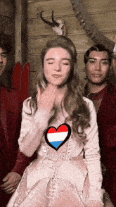 a woman in a pink dress with a heart on her chest says right now