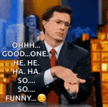 a man in a suit and tie is making a funny face while talking on a television show .