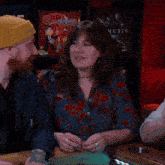 a man and a woman are sitting at a table with the words it 's a team game written on the table