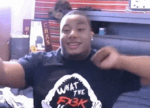a man is wearing a black shirt that says what the fx3k
