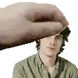 a hand is touching a man 's forehead in a pixel art .