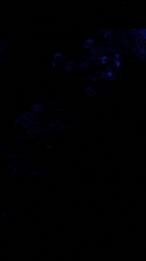 a man and a woman are hugging and the woman is holding a glowing object in her hand