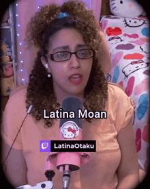 a woman with curly hair is wearing glasses and a pink shirt with a hello kitty sticker on it