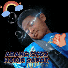 a boy wearing a blue shirt with the words abang syaz hadir sapot written on it