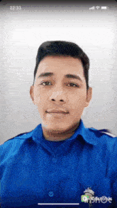 a man in a blue shirt is looking at the camera with the time of 22:31