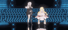 two anime girls are dancing on a stage in front of a polka dot background