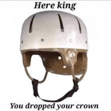 a white helmet with the words `` here king you dropped your crown '' written on it is on a white background .