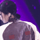 a close up of a person 's back with a letter m on it