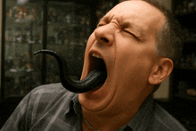 a man is yawning with his tongue sticking out