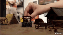 a person is playing a game with a wheelbarrow and a well