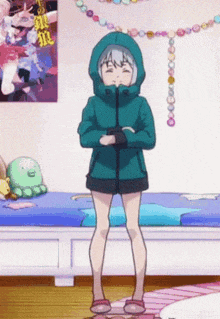 a girl in a green jacket is standing in a bedroom