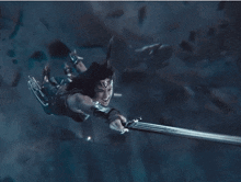a woman is flying through the air with a sword
