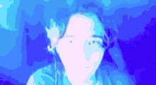 a blurry picture of a person 's face in a blue light .