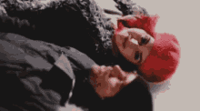 a man and a woman are laying on top of each other in the snow with the words `` i love you '' above them .