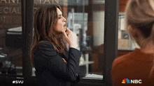 a nbc ad shows a woman biting her finger