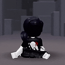 a person with a skull on their back is sitting on the floor