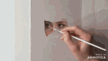 a person is painting a portrait of a woman with a brush .