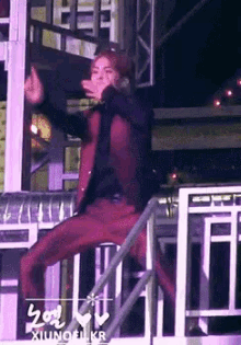 a man in red pants is standing on a staircase and giving the middle finger ..