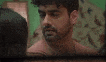 a close up of a woman 's face with a man 's arm around her shoulder .