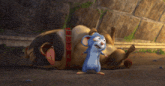 a blue mouse is standing next to a dog that is laying down