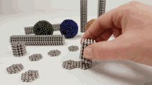 a person is playing with a bunch of magnets and balls