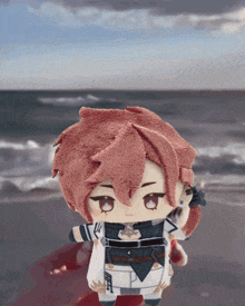 a stuffed doll with red hair is standing in front of a body of water