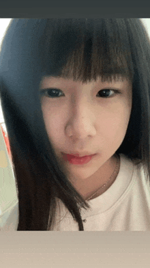 a close up of a girl 's face with a necklace around her neck