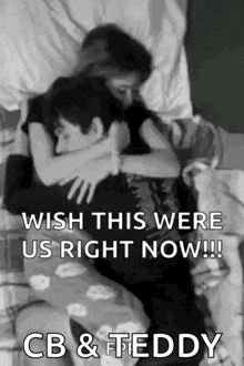 a black and white photo of a man and a woman hugging each other on a bed .