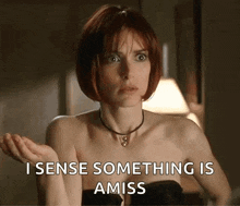 a woman with red hair and a necklace says " i sense something is amiss "