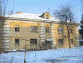 a photo of a building taken by hailuo ai shows snow on the ground and icicles on the roof