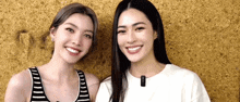two women are posing for a picture and smiling for the camera