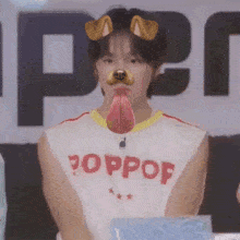 a man wearing a poppop shirt with a dog face mask on his face .
