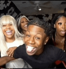 a group of people are posing for a picture with one man sticking his tongue out .