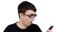 a man wearing glasses and a black sweater is looking at a cell phone