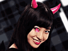 a woman with horns on her head is smiling