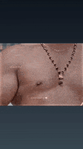 a shirtless man in a towel is holding a tray of food .