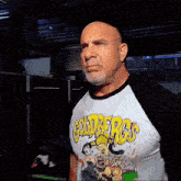 a bald man wearing a shirt that says goldbergs