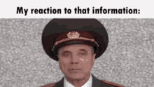 a man wearing a military hat with the words my reaction to that information written below him