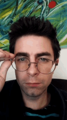 a man wearing glasses is making a funny face