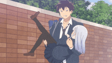 a boy is carrying a girl in his arms and the girl is looking at him