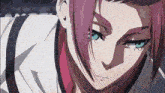 a close up of a person with pink hair and blue eyes