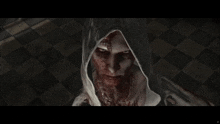 a close up of a person with blood on their face and a hood