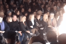 a crowd of people sitting in a stadium watching a show