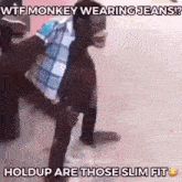 a man with a monkey on his back is wearing jeans and a plaid shirt .