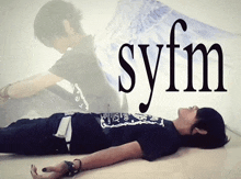 a person laying on the floor with the word syfm written on the bottom