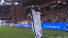 a soccer player stands in front of a sign that says ' never ' on it