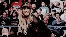 a woman is dancing in front of a crowd of people .