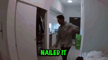 a man is standing in a room with the words nailed it written on the wall