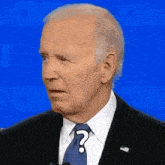 a close up of a man in a suit and tie with a question mark on his forehead .