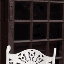 a white chair is sitting in front of a door that has a lightning bolt coming out of it